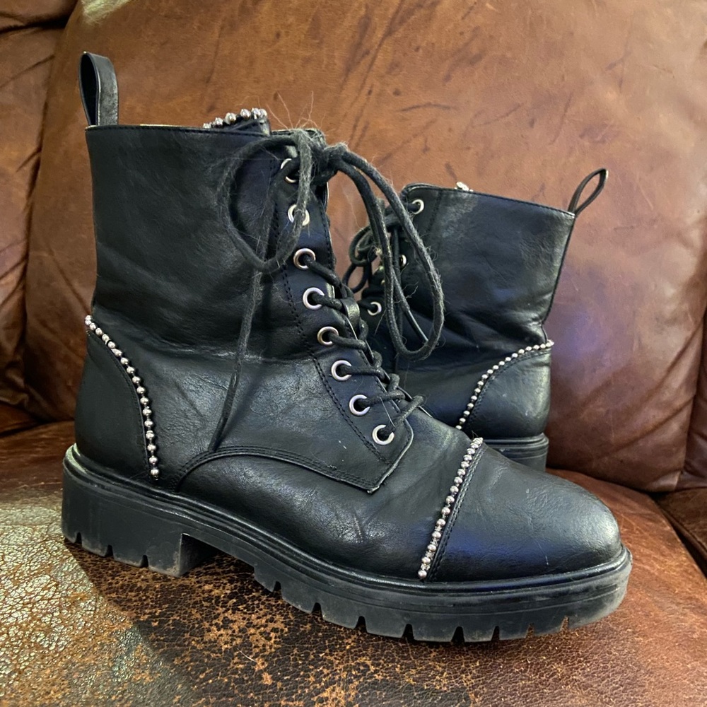 Size 10 Womens black combat boots with silver accents, black zipper on the sides